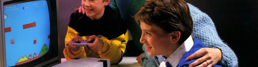 A child playing nintendo with his family
